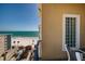 Enjoy beach views from this cozy balcony with chairs, facing the beach and blue sea at 13600 Gulf Blvd # 700A, St Petersburg, FL 33708
