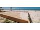 Direct access to the beach with a fence and grassy area at 13600 Gulf Blvd # 700A, St Petersburg, FL 33708