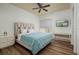 Cozy bedroom featuring wood floors, a comfortable bed, and a flat screen television at 13600 Gulf Blvd # 700A, St Petersburg, FL 33708