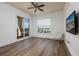 Airy bedroom with hardwood floors, a ceiling fan, balcony access and TV at 13600 Gulf Blvd # 700A, St Petersburg, FL 33708
