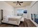 Spacious bedroom showcasing hardwood floors, a ceiling fan, and a window overlooking the city at 13600 Gulf Blvd # 700A, St Petersburg, FL 33708