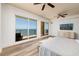 Bright bedroom with balcony overlooking the ocean, wood floors, and a comfortable bed at 13600 Gulf Blvd # 700A, St Petersburg, FL 33708