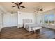 Spacious bedroom featuring wood floors, a large window, and a stylish bed frame at 13600 Gulf Blvd # 700A, St Petersburg, FL 33708