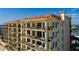 Exterior corner view of a multi-story building, showcasing private balconies with stunning views at 13600 Gulf Blvd # 700A, St Petersburg, FL 33708