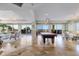 Large game room featuring billiard table, refined lighting, and access to a balcony with ocean views at 13600 Gulf Blvd # 700A, St Petersburg, FL 33708