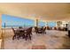 Spacious outdoor terrace with tile flooring, multiple seating areas, and beautiful beach views at 13600 Gulf Blvd # 700A, St Petersburg, FL 33708