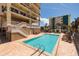 Inviting outdoor pool with lounge chairs in a resort style setting at 13600 Gulf Blvd # 700A, St Petersburg, FL 33708