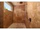 Walk-in shower with travertine walls and floors, featuring a rainfall shower head at 13600 Gulf Blvd # 700A, St Petersburg, FL 33708