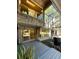Unique home exterior with glass-enclosed porch and lush landscaping, showcasing modern architecture at 1602 Cottagewood Dr, Brandon, FL 33510