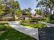 Inviting property featuring a circular driveway, mature trees, and unique architectural elements at 1602 Cottagewood Dr, Brandon, FL 33510
