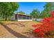 Exterior view of home with screened porch and landscaped yard at 1610 Navigator Ln, Tarpon Springs, FL 34689