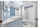 Well-lit bathroom featuring a tub-shower combo, modern square sink and vanity with ample storage at 1610 Navigator Ln, Tarpon Springs, FL 34689