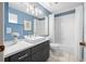 Contemporary bathroom with blue walls, modern vanity, and tiled shower at 1610 Navigator Ln, Tarpon Springs, FL 34689