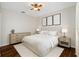 Serene bedroom featuring a ceiling fan, hardwood floors, and modern decor at 1610 Navigator Ln, Tarpon Springs, FL 34689