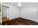 Simple bedroom featuring wood floors, a ceiling fan, and a closet in a home at 1610 Navigator Ln, Tarpon Springs, FL 34689