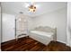 Bright bedroom with wood floors featuring daybed, a ceiling fan, and a painted wooden dresser at 1610 Navigator Ln, Tarpon Springs, FL 34689