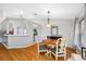 Cozy dining area featuring wood floors and a view into the kitchen, ideal for Gathering meals at 1610 Navigator Ln, Tarpon Springs, FL 34689