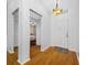 Inviting entryway featuring wood floors, high ceilings, and a decorative light fixture at 1610 Navigator Ln, Tarpon Springs, FL 34689