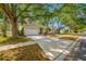 Lovely home with mature shade trees, a well-manicured lawn, and an extended driveway at 1610 Navigator Ln, Tarpon Springs, FL 34689