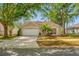 Charming single-story home featuring a well-maintained lawn and mature trees for ample shade and privacy at 1610 Navigator Ln, Tarpon Springs, FL 34689