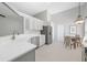 Well-lit kitchen featuring white cabinets, stainless steel appliances, and patterned flooring at 1610 Navigator Ln, Tarpon Springs, FL 34689