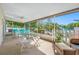 Relaxing screened patio features a ceiling fan and plenty of room for outdoor dining and entertaining at 1610 Navigator Ln, Tarpon Springs, FL 34689