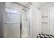 Bathroom shower with glass doors, white tile, and tiled seat inside in home at 1610 Navigator Ln, Tarpon Springs, FL 34689