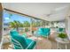 Bright sunroom featuring outdoor seating and a view of the backyard and pool at 1610 Navigator Ln, Tarpon Springs, FL 34689