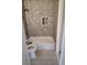 Cozy bathroom with tiled walls, a bathtub, and a built-in niche, offering a relaxing space at 1615 Stevensons Dr, Clearwater, FL 33755