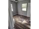 Bright bedroom featuring hardwood floors, ample natural light, and neutral paint at 1615 Stevensons Dr, Clearwater, FL 33755