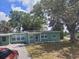Charming single-story home featuring a well-maintained lawn and mature trees at 1615 Stevensons Dr, Clearwater, FL 33755
