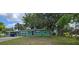 Charming single-story home featuring a well-maintained lawn and mature trees at 1615 Stevensons Dr, Clearwater, FL 33755