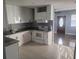 Bright kitchen with white cabinets, granite counters, and stainless steel appliances for a modern look at 1615 Stevensons Dr, Clearwater, FL 33755