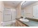 Bathroom with a tub and shower and a vanity with a large mirror and lighting at 1632 Gray Bark Dr, Oldsmar, FL 34677
