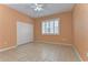 A neutral bedroom is brightened with natural light, featuring a large closet and tile floors at 1632 Gray Bark Dr, Oldsmar, FL 34677