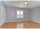Bedroom with wood floors, a ceiling fan, and a window with plantation shutters at 1632 Gray Bark Dr, Oldsmar, FL 34677
