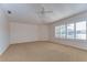 Large bedroom featuring carpet flooring, a ceiling fan, and window with plantation shutters at 1632 Gray Bark Dr, Oldsmar, FL 34677