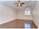 Sun-filled bedroom featuring a ceiling fan, beautiful window with coverings, and neutral paint tones at 1632 Gray Bark Dr, Oldsmar, FL 34677