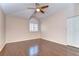Bright bedroom with hardwood floors, ceiling fan and a large window letting in plenty of natural light at 1632 Gray Bark Dr, Oldsmar, FL 34677