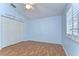 Spacious bedroom featuring wood floors, a ceiling fan, and double closets for ample storage at 1632 Gray Bark Dr, Oldsmar, FL 34677