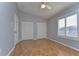 Light-filled bedroom featuring hardwood floors, double closets, and a large window at 1632 Gray Bark Dr, Oldsmar, FL 34677
