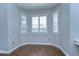 Dining area with wood flooring, large windows with shutters, and natural light at 1632 Gray Bark Dr, Oldsmar, FL 34677