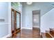 Elegant entryway with hardwood floors, chandelier, and decorative front door with glass panels at 1632 Gray Bark Dr, Oldsmar, FL 34677