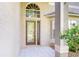 Close-up of the front door showing a glass insert and transom window above at 1632 Gray Bark Dr, Oldsmar, FL 34677