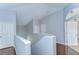 Upstairs hallway featuring hardwood floors and access to rooms via white paneled doors at 1632 Gray Bark Dr, Oldsmar, FL 34677