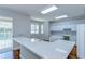 Bright kitchen featuring a white quartz countertop island and an open design with backyard views at 1632 Gray Bark Dr, Oldsmar, FL 34677