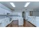 Spacious kitchen featuring white cabinets, stainless steel appliances, and a convenient center island at 1632 Gray Bark Dr, Oldsmar, FL 34677
