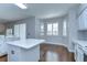 Kitchen featuring white cabinetry, stainless steel appliances, and an island for additional workspace at 1632 Gray Bark Dr, Oldsmar, FL 34677