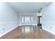 Bright living room featuring hardwood floors, crown molding, and large windows that offer plenty of natural light at 1632 Gray Bark Dr, Oldsmar, FL 34677