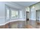 Elegant living room features wood floors, large windows with shutters, and a decorative chandelier at 1632 Gray Bark Dr, Oldsmar, FL 34677